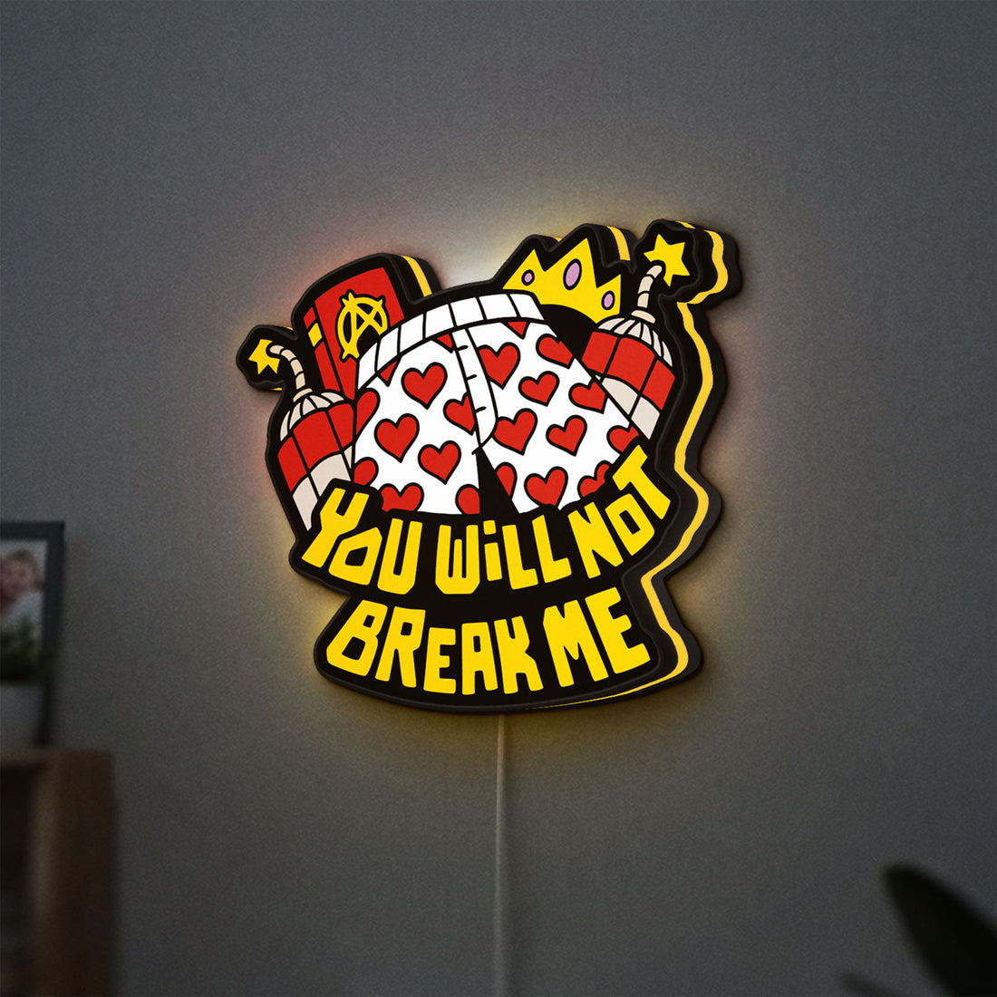 You Will Not Break Me Quote LED lightbox hanging on a wall with yellow glow