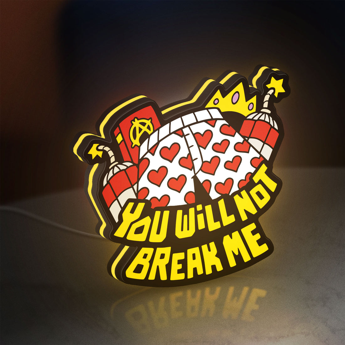 You Will Not Break Me Quote LED lightbox hanging on a wall with yellow glow