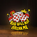 Front view of You Will Not Break Me Quote LED lightbox sign glowing on a wooden desk