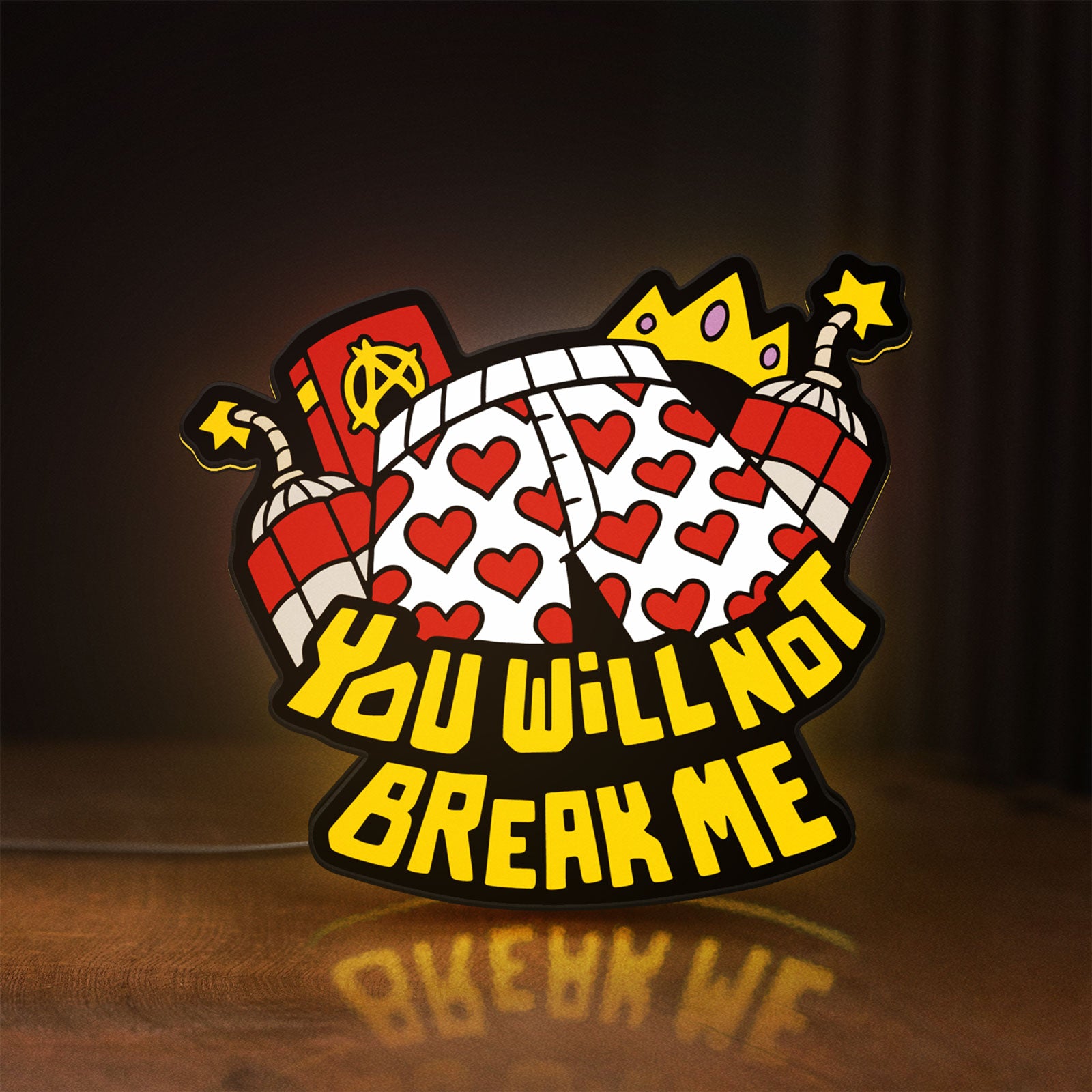 Front view of You Will Not Break Me Quote LED lightbox sign glowing on a wooden desk