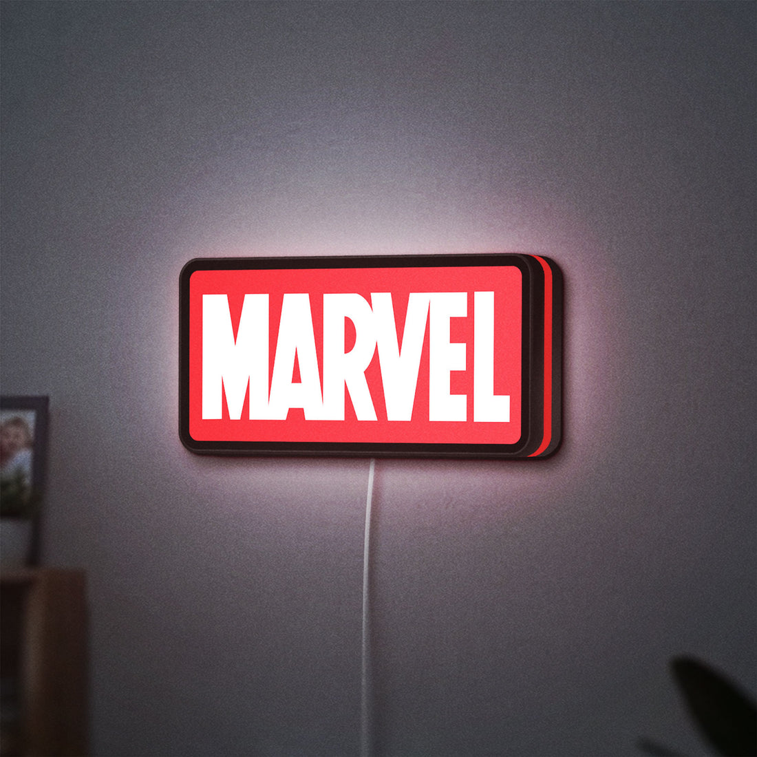 Marvel Comics LED lightbox hanging on a wall with red glow