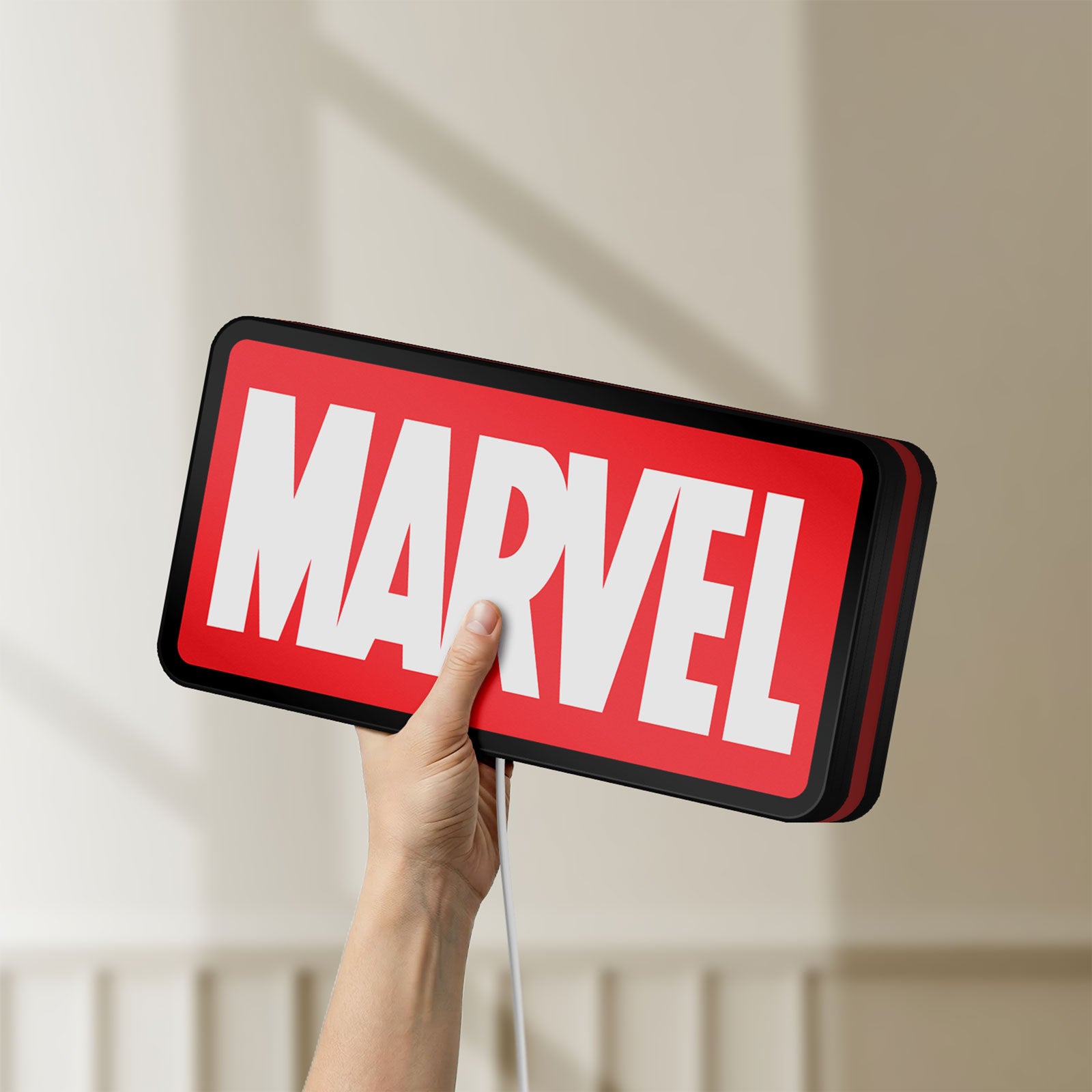Unlit Marvel Comics LED lightbox held by hand to show size and details