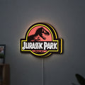 Jurassic Park LED lightbox hanging on a wall with yellow glow