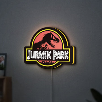 Jurassic Park LED lightbox hanging on a wall with yellow glow