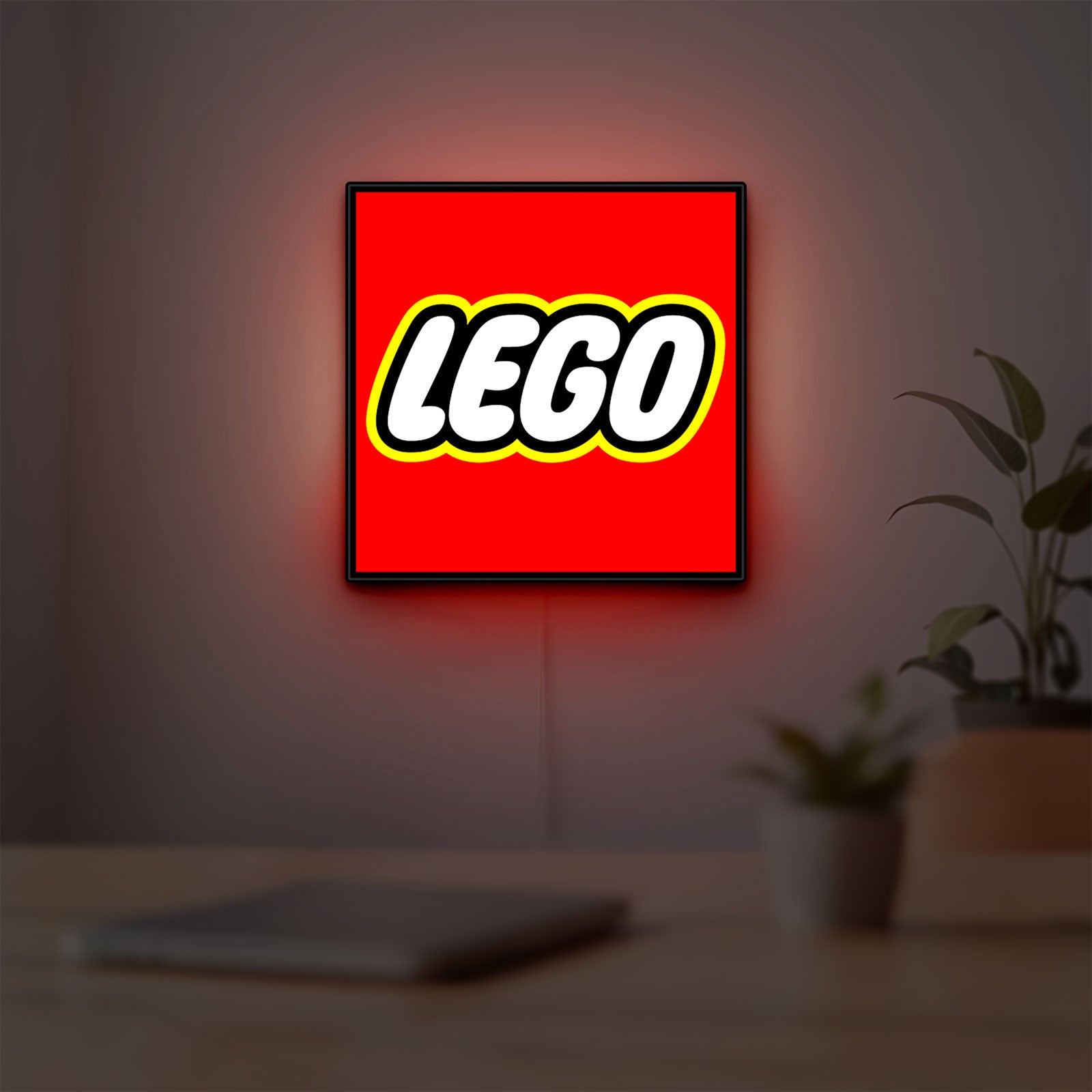 Lego Inspired LED lightbox hanging on a room wall with soft red light