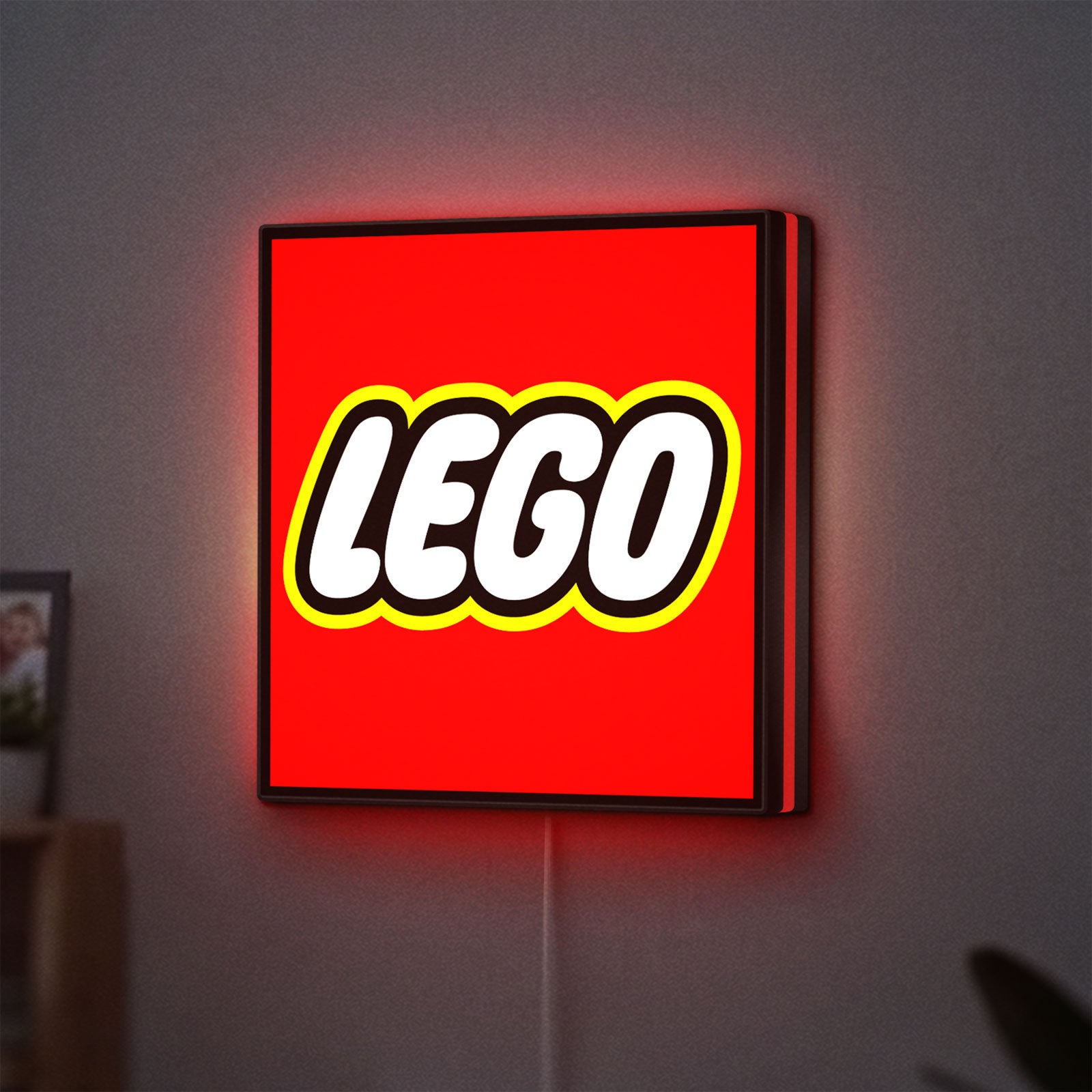Lego Inspired LED lightbox hanging on a wall with red glow