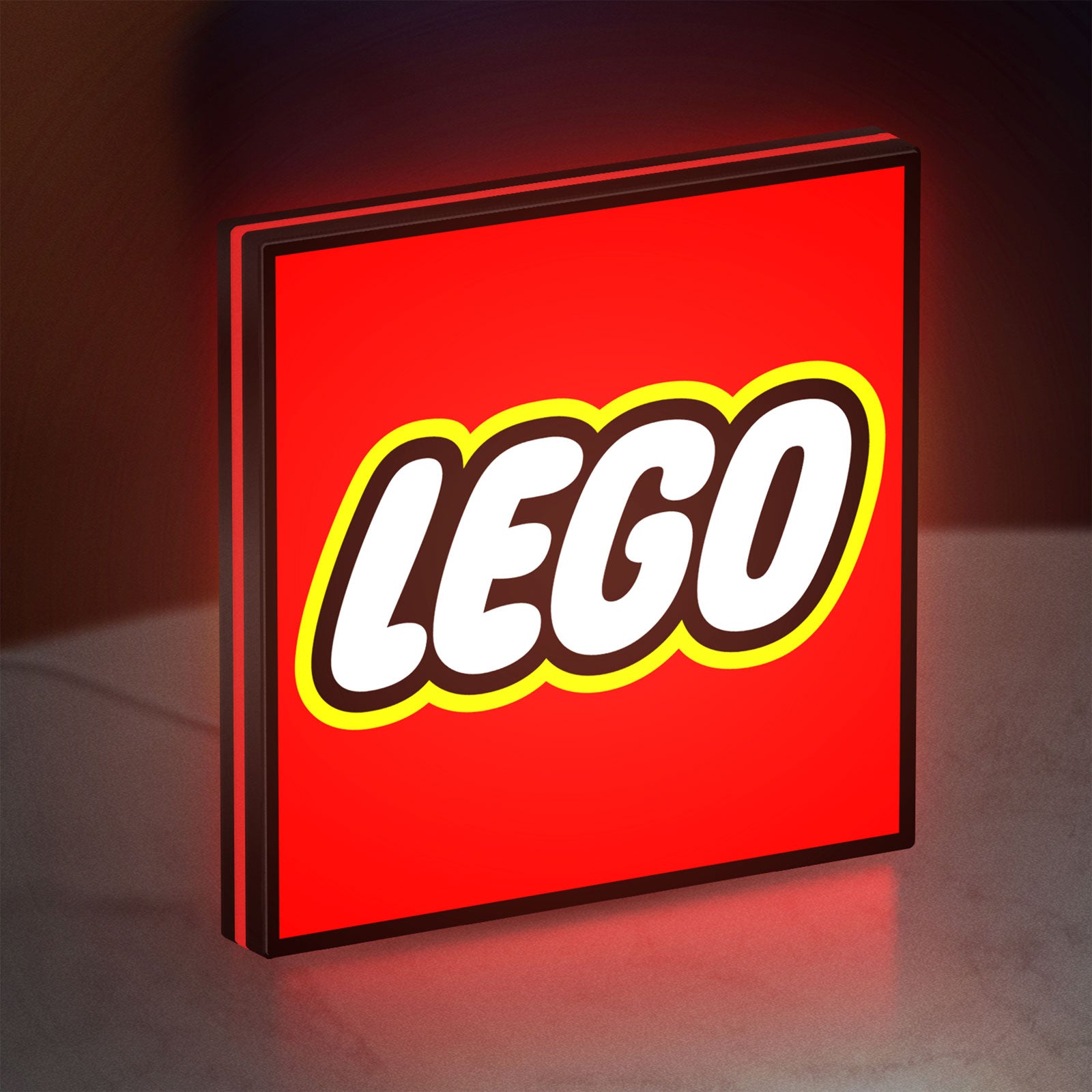 Lego Inspired LED lightbox standing on a desk from an angled side view with red glow