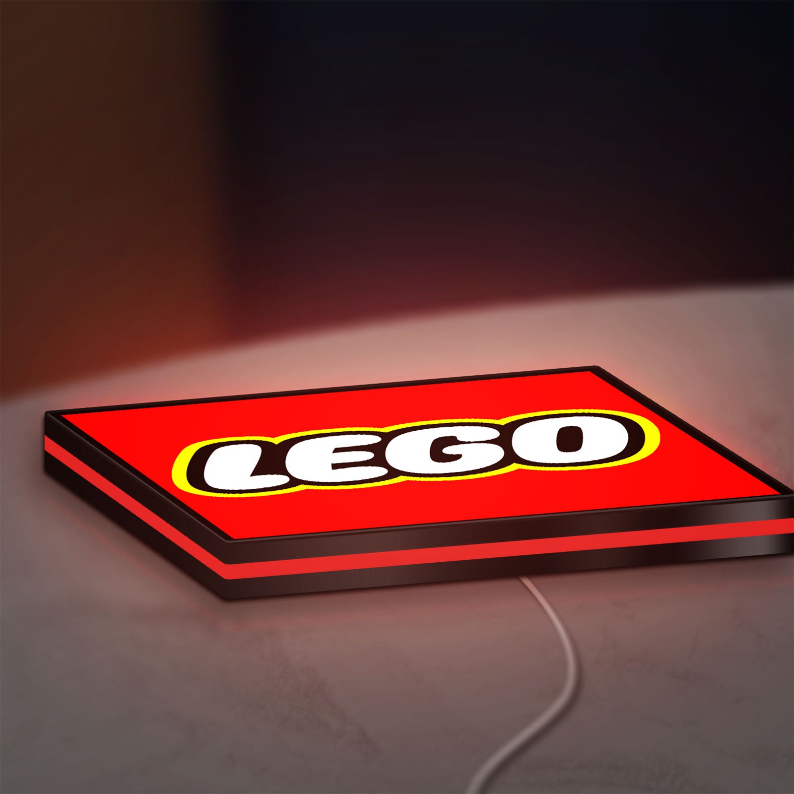 Lego Inspired LED lightbox lying flat on a desk with red glow
