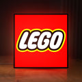 Front view of Lego Inspired LED lightbox sign glowing on a wooden desk