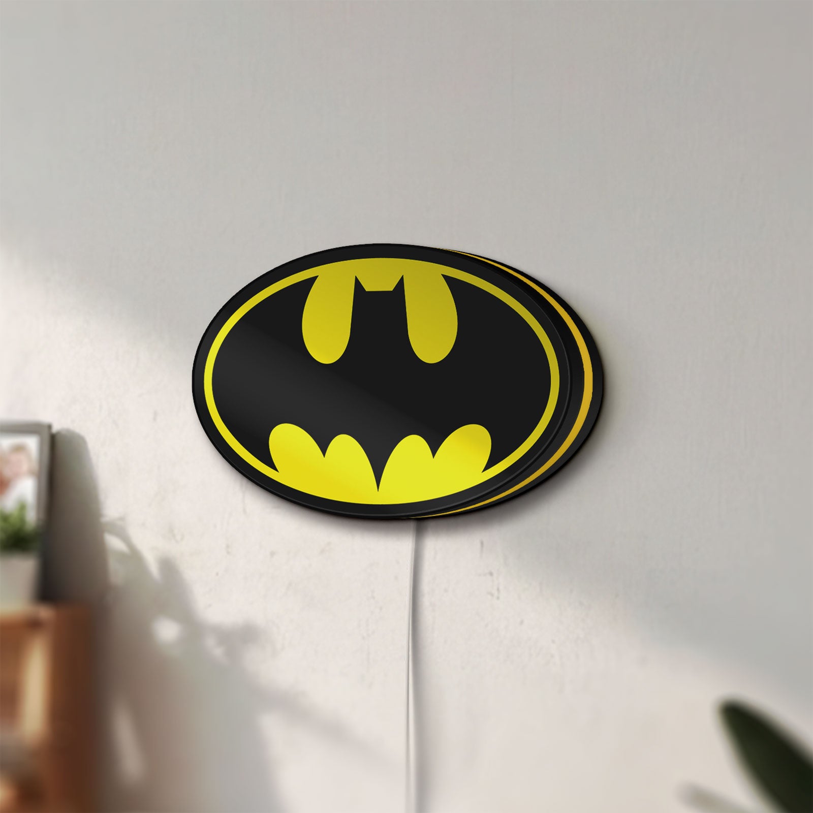 Unlit Batman LED lightbox mounted on a wall in daylight