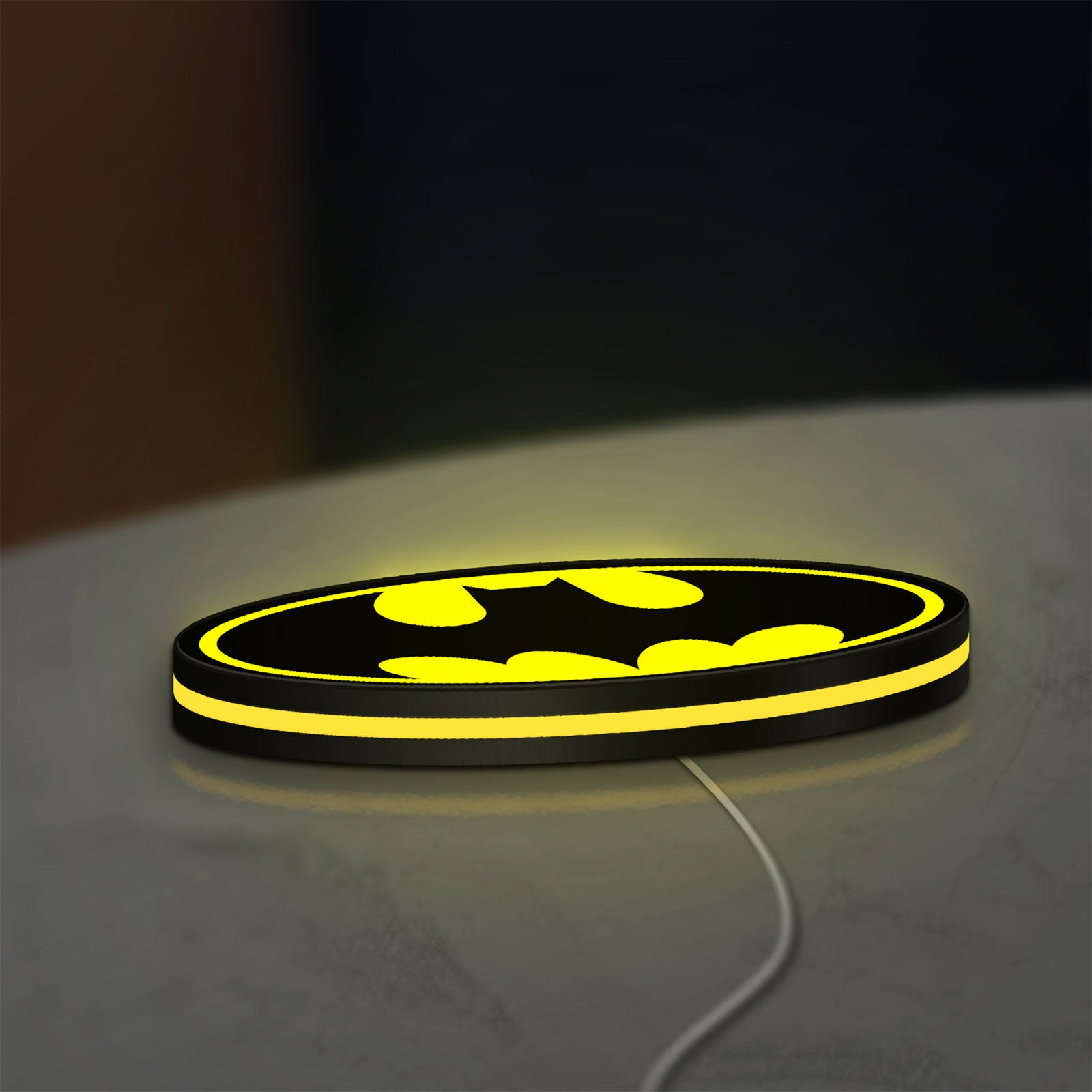 Batman LED lightbox lying flat on a desk with yellow glow