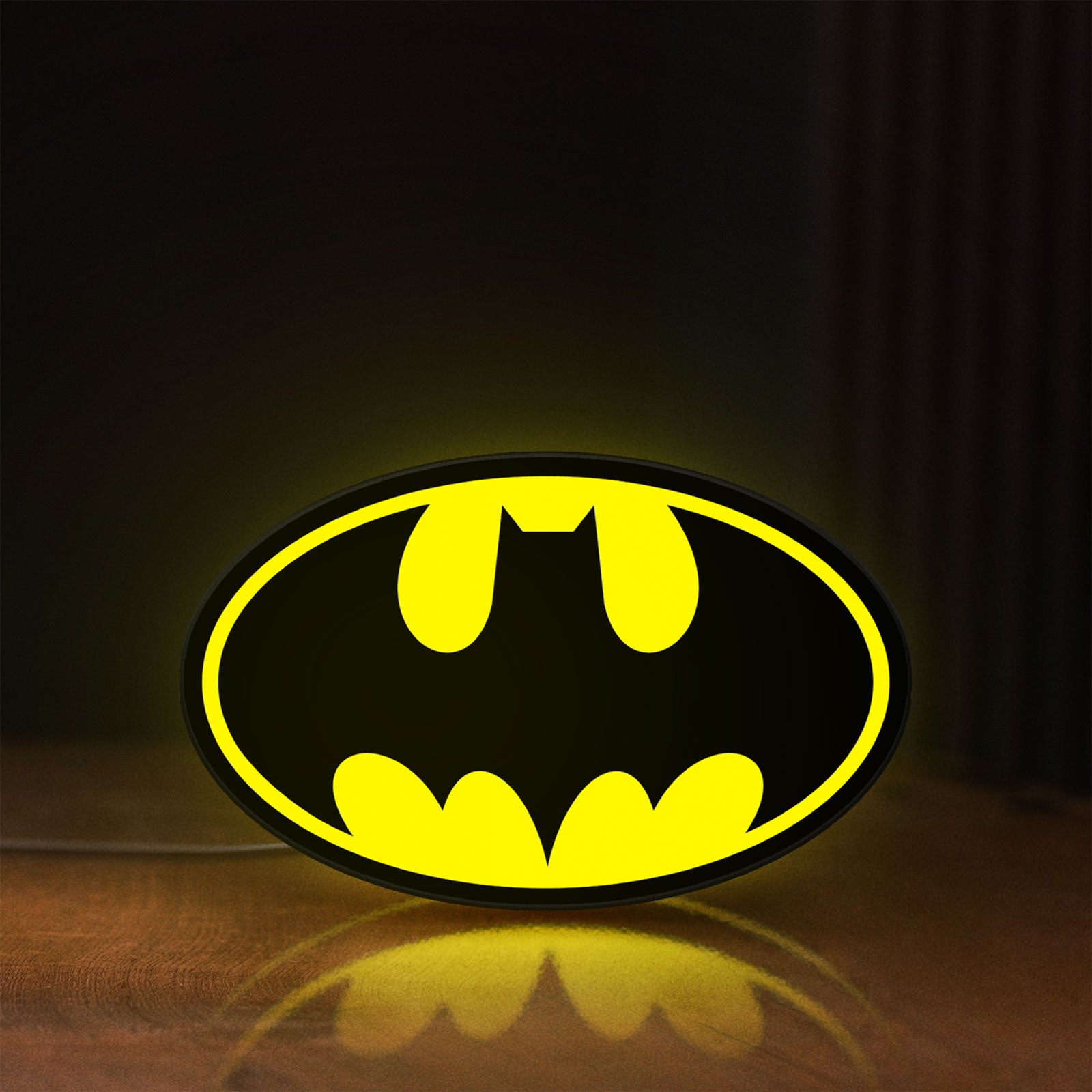 Front view of Batman LED lightbox sign glowing on a wooden desk