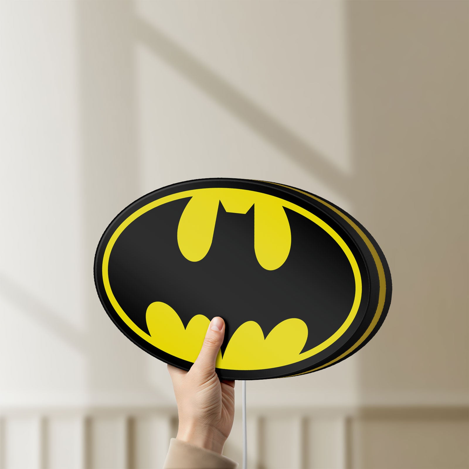 Unlit Batman LED lightbox held by hand to show size and details
