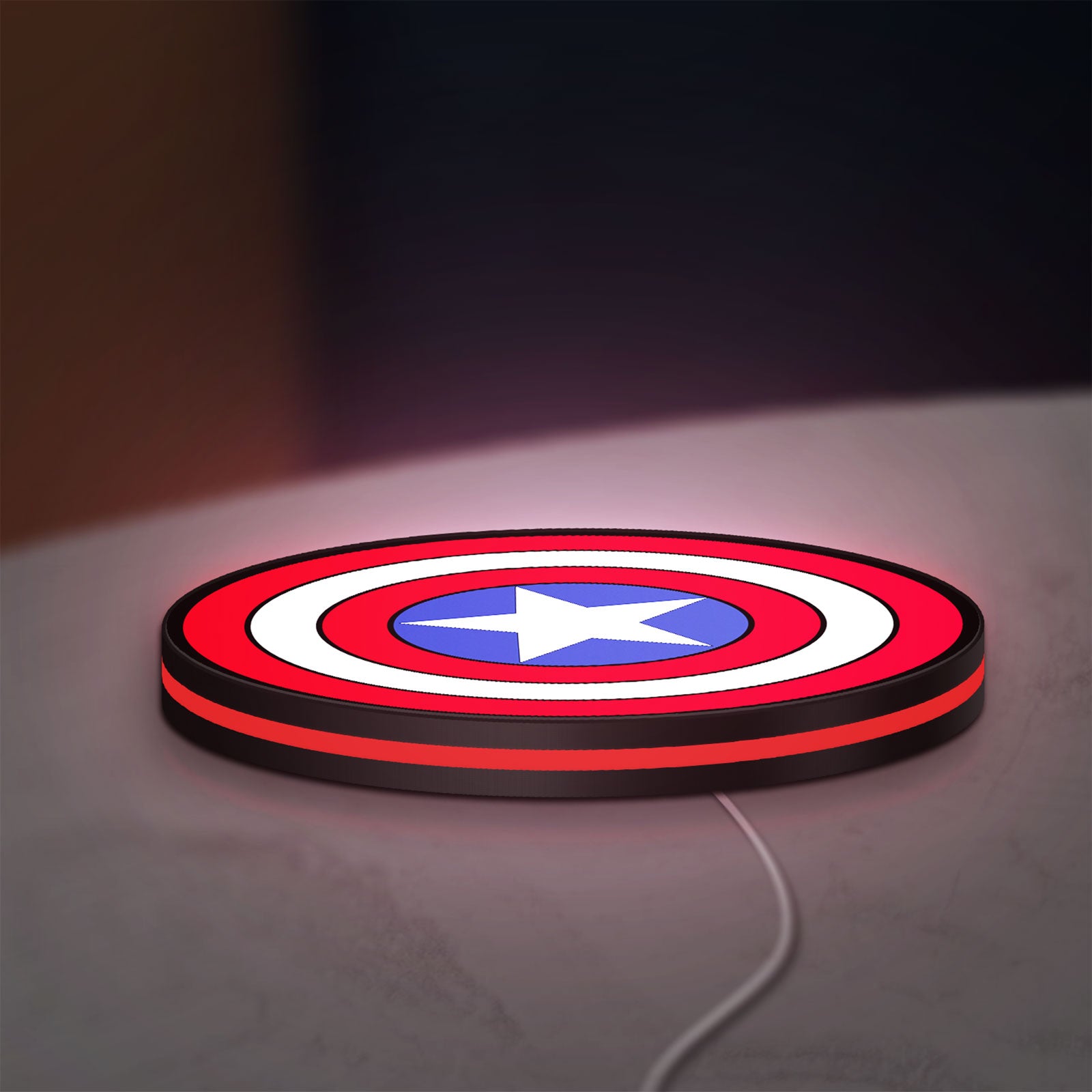 Captain America LED lightbox lying flat on a desk with red glow