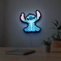 Disney Stitch LED lightbox hanging on a room wall with soft blue light