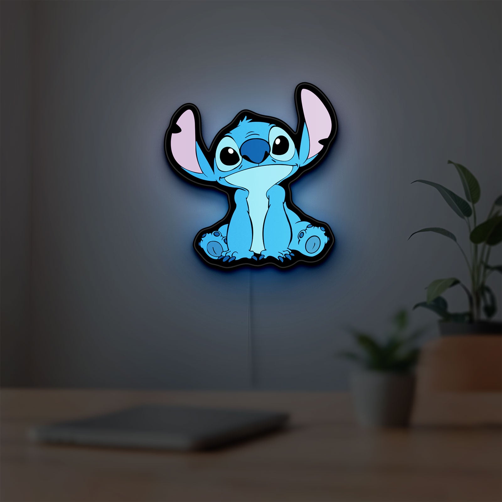 Disney Stitch LED lightbox hanging on a room wall with soft blue light