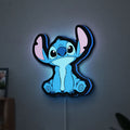 Disney Stitch LED lightbox hanging on a wall with blue glow