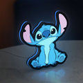 Disney Stitch LED lightbox standing on a desk from an angled side view with blue glow