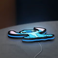 Disney Stitch LED lightbox lying flat on a desk with blue glow
