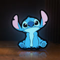 Front view of Disney Stitch LED lightbox sign glowing on a wooden desk