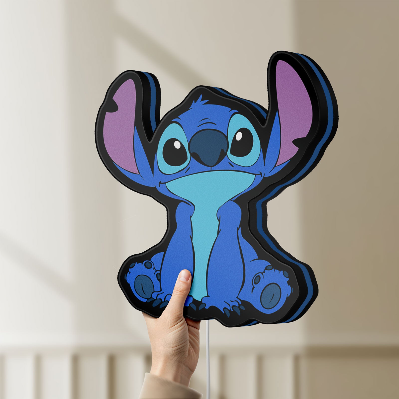 Unlit Disney Stitch LED lightbox held by hand to show size and details