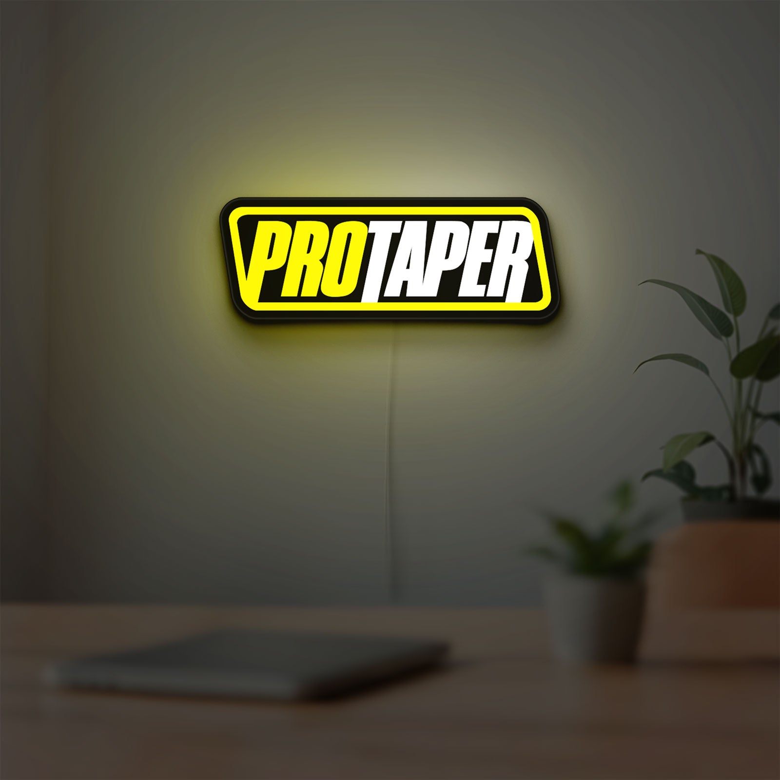 Pro Taper LED lightbox hanging on a room wall with soft yellow light