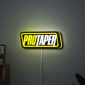 Pro Taper LED lightbox hanging on a wall with yellow glow