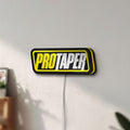 Unlit Pro Taper LED lightbox mounted on a wall in daylight