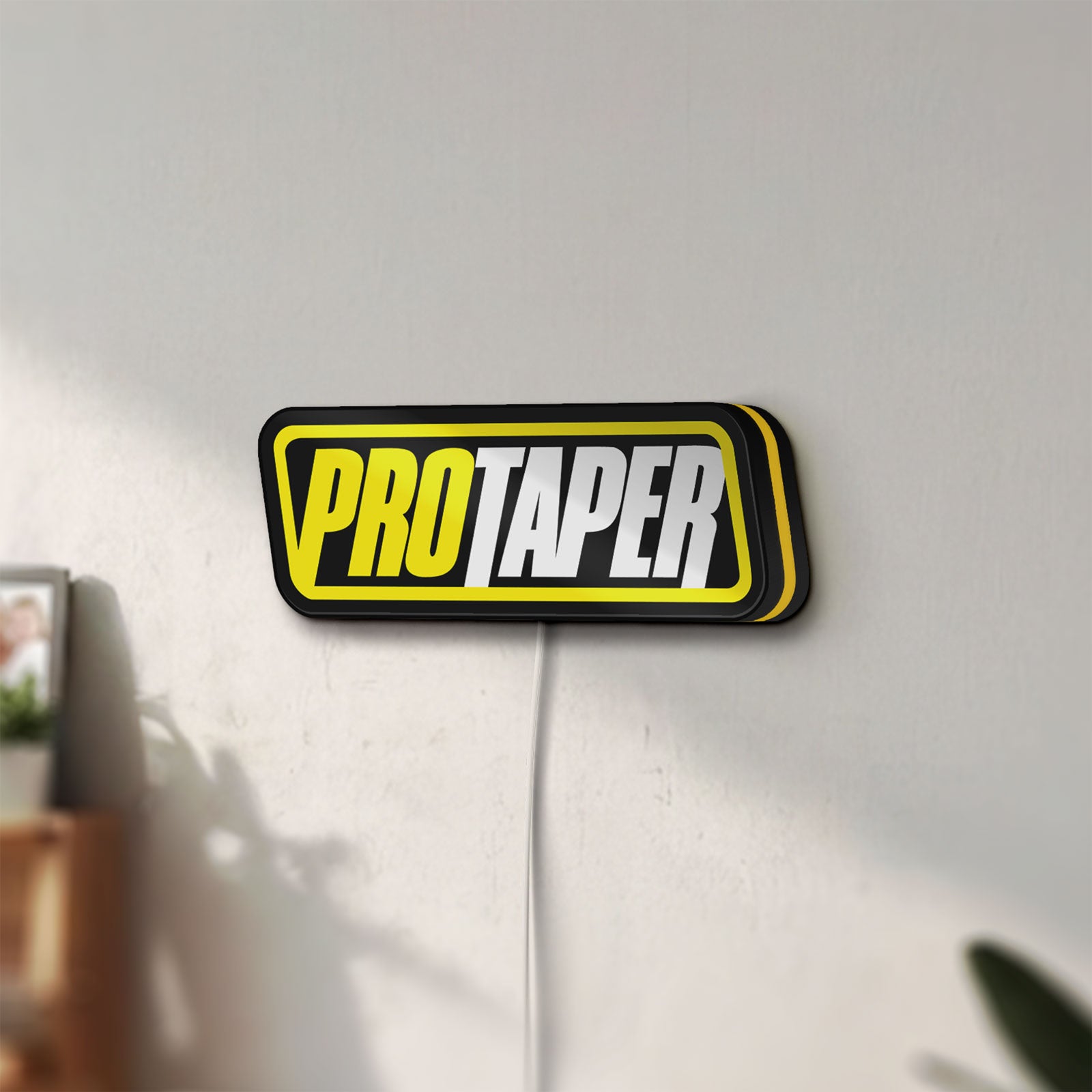 Unlit Pro Taper LED lightbox mounted on a wall in daylight