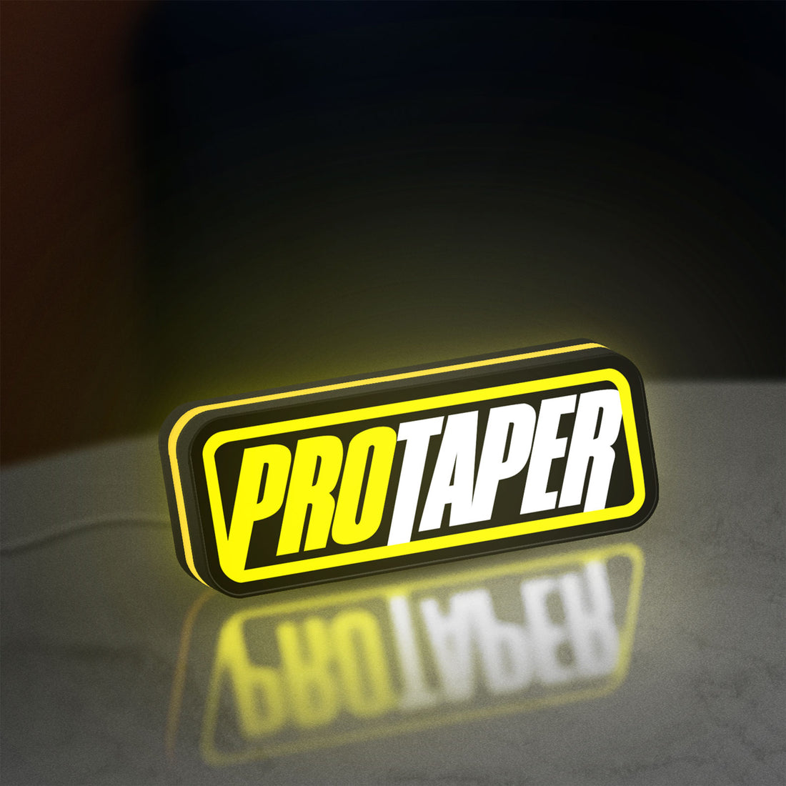 Pro Taper LED lightbox hanging on a wall with yellow glow