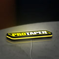 Pro Taper LED lightbox lying flat on a desk with yellow glow
