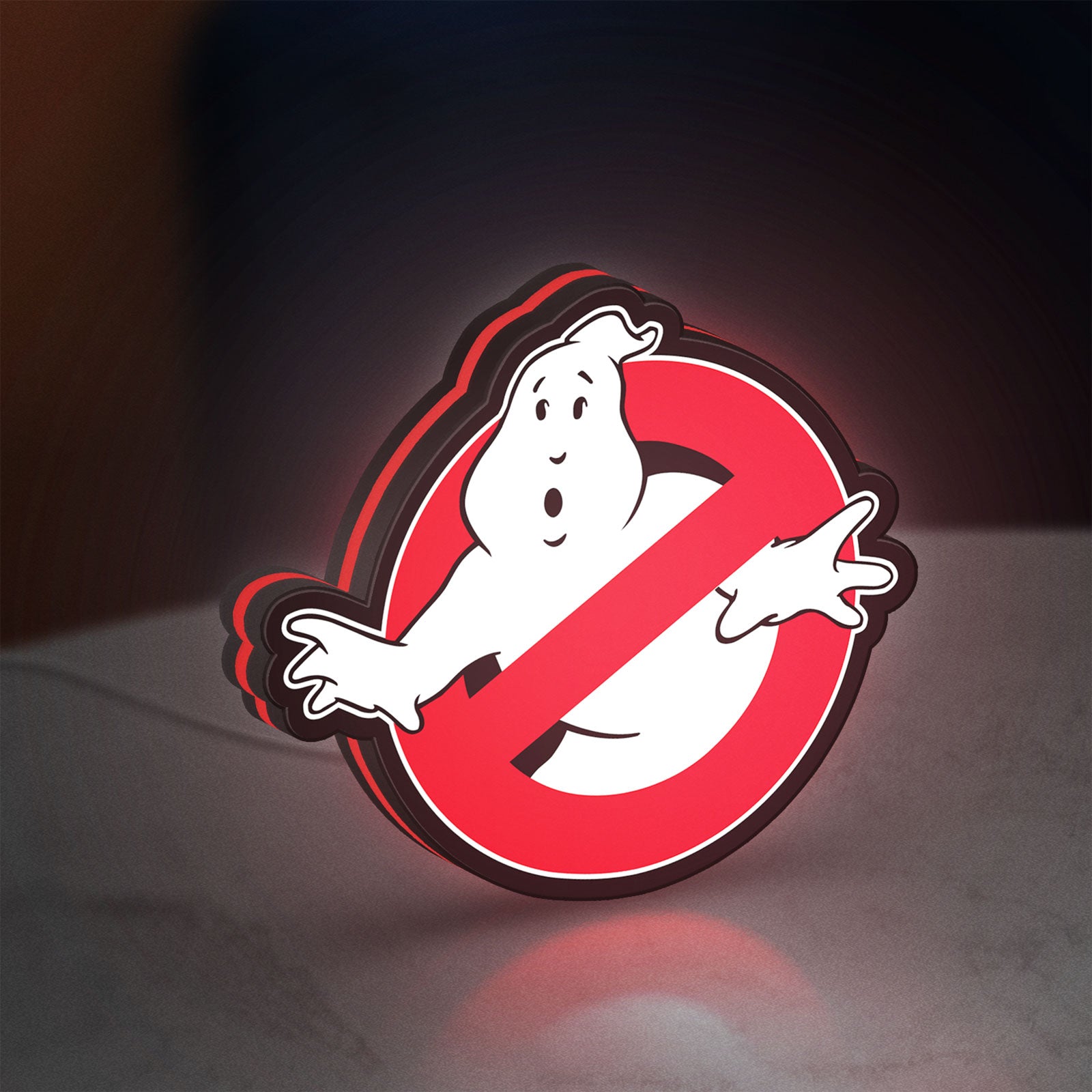 Ghostbusters LED lightbox standing on a desk from an angled side view with red glow