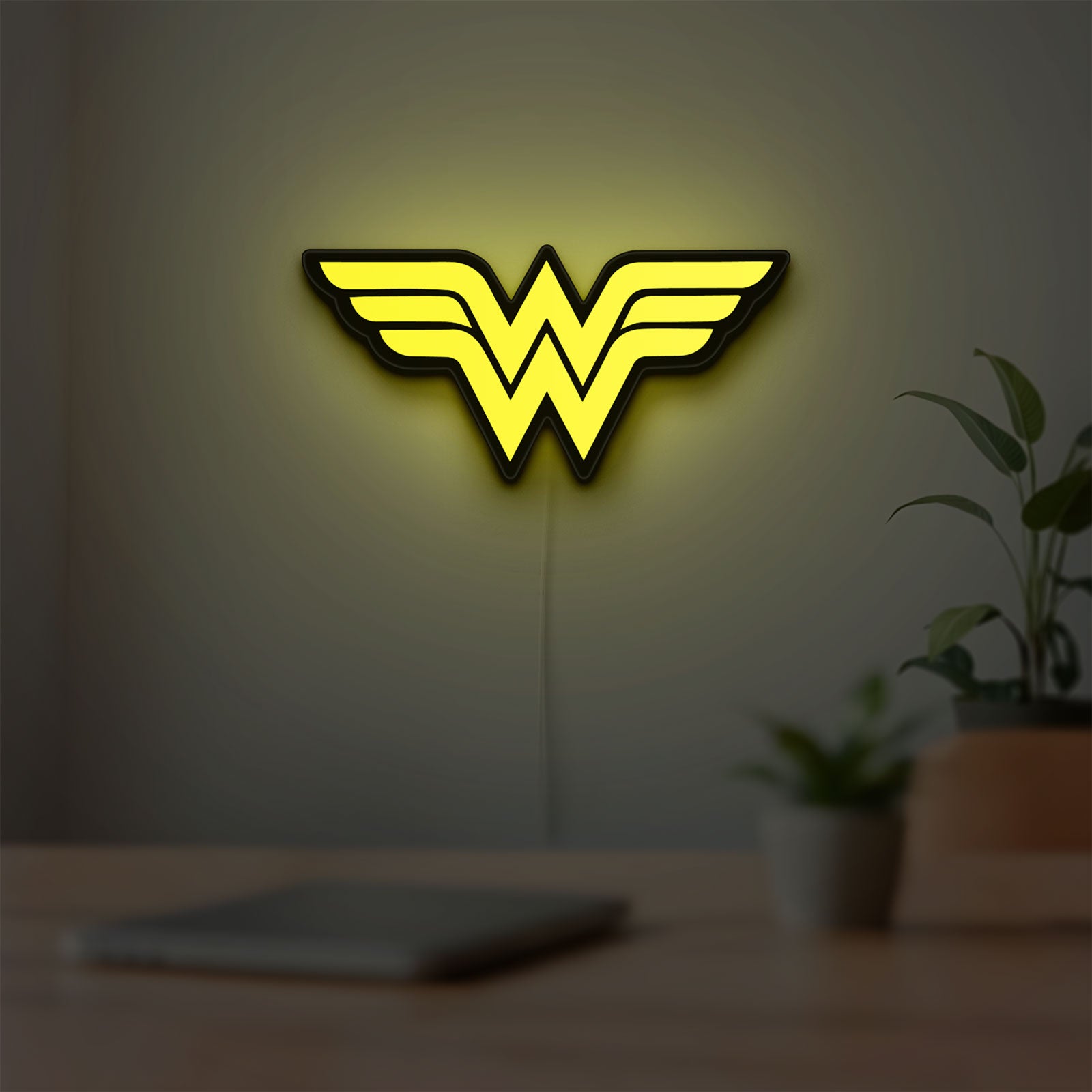 WONDER WOMAN LED lightbox hanging on a room wall with soft yellow light