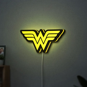 WONDER WOMAN LED lightbox hanging on a wall with yellow glow