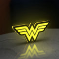 WONDER WOMAN LED lightbox standing on a desk from an angled side view with yellow glow