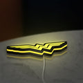 WONDER WOMAN LED lightbox lying flat on a desk with yellow glow