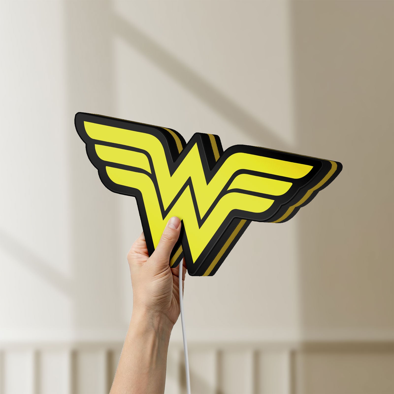 Unlit WONDER WOMAN LED lightbox held by hand to show size and details