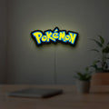 Pokemon LED lightbox hanging on a room wall with soft yellow light