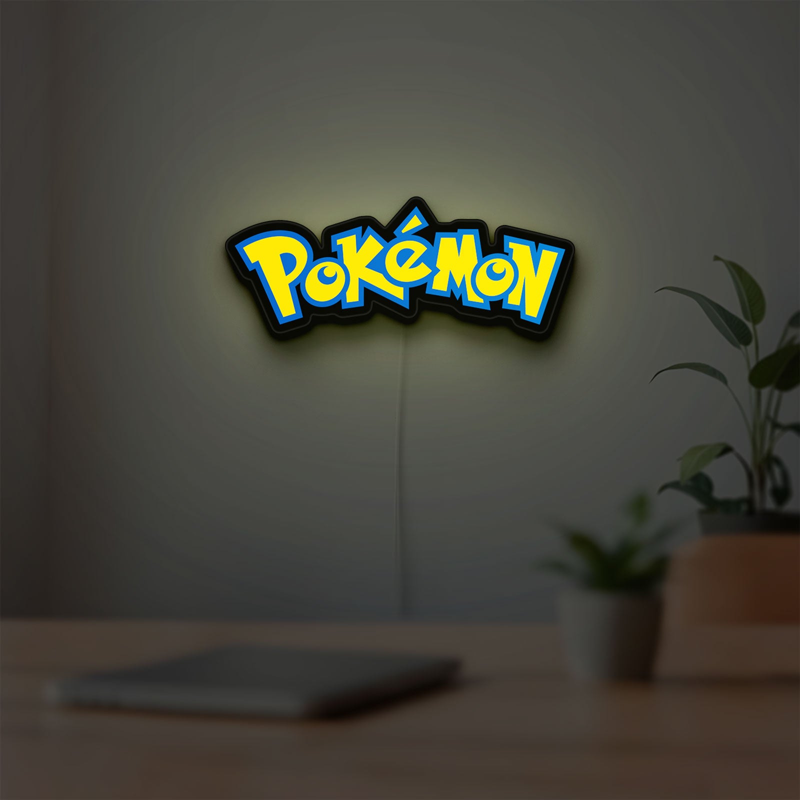 Pokemon LED lightbox hanging on a room wall with soft yellow light