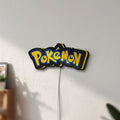 Unlit Pokemon LED lightbox mounted on a wall in daylight