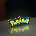 Pokemon LED lightbox standing on a desk from an angled side view with yellow glow