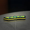 Pokemon LED lightbox lying flat on a desk with yellow glow