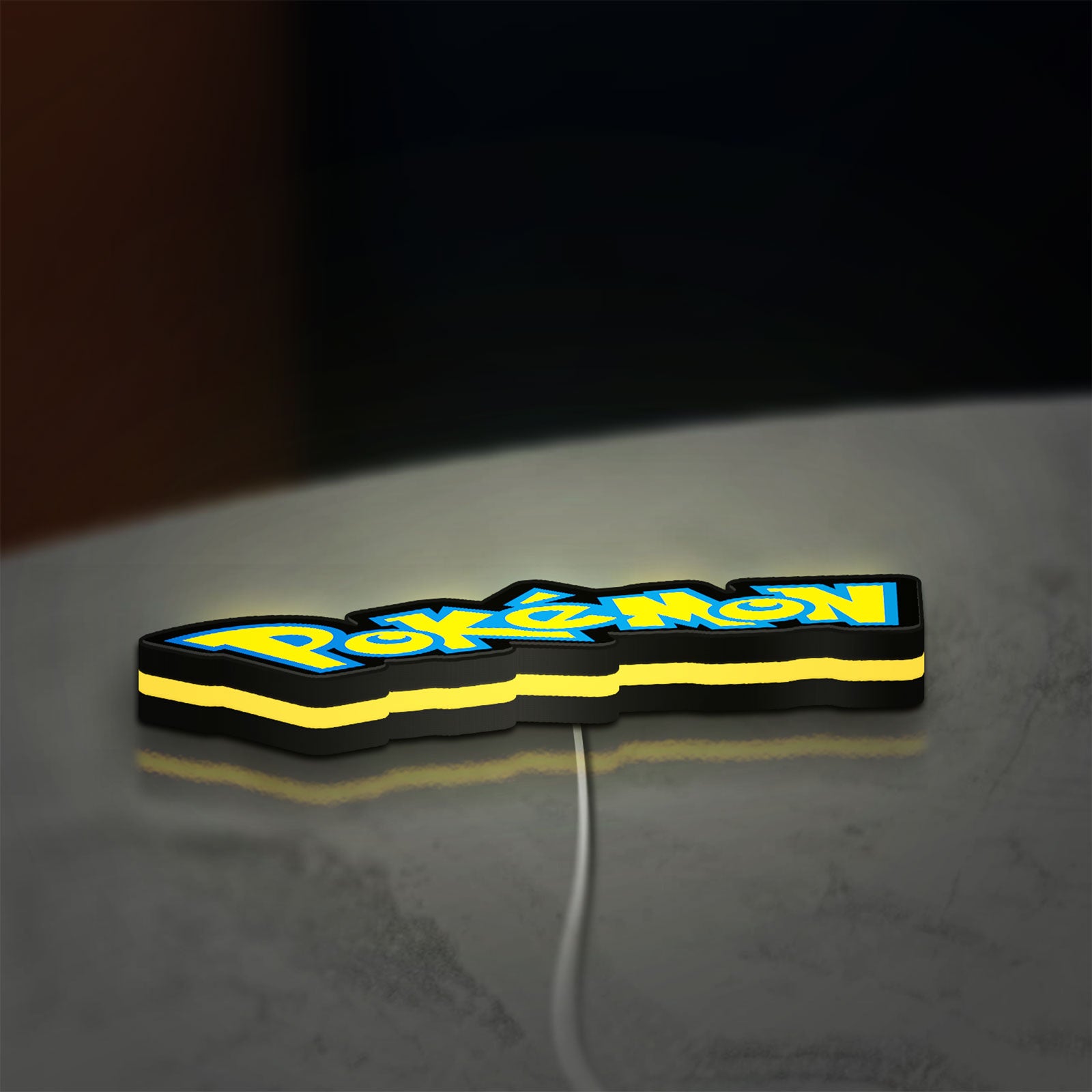 Pokemon LED lightbox lying flat on a desk with yellow glow