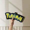 Unlit Pokemon LED lightbox held by hand to show size and details