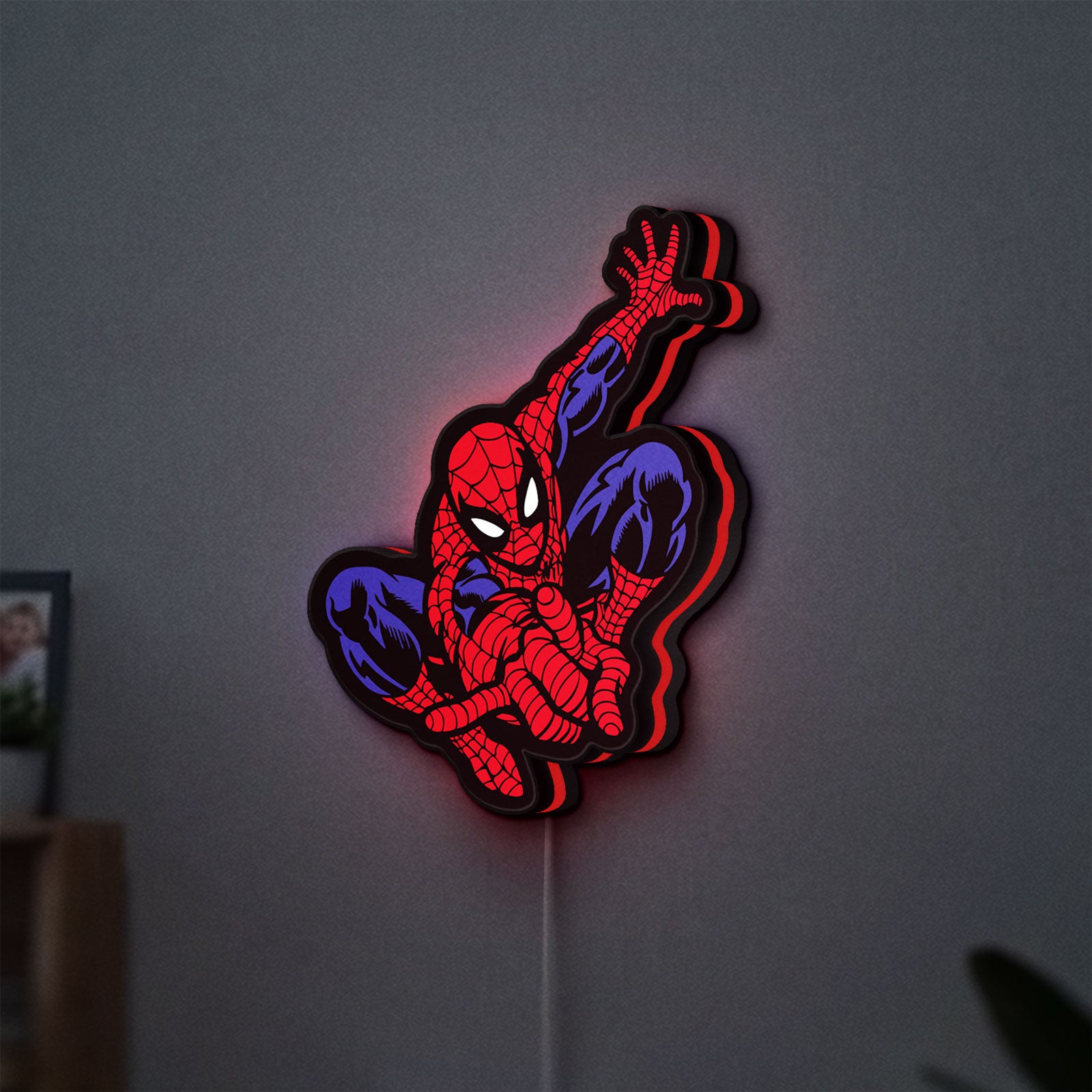 Spider-Man LED lightbox hanging on a wall with red glow