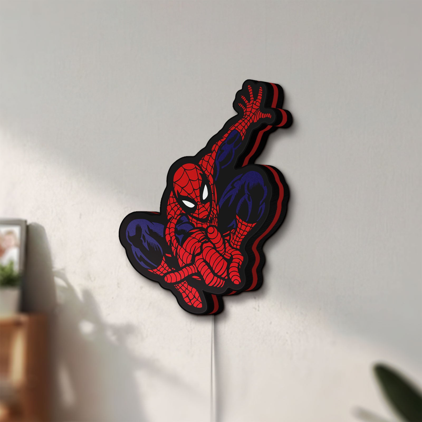 Unlit Spider-Man LED lightbox mounted on a wall in daylight