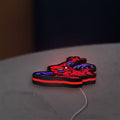Spider-Man LED lightbox lying flat on a desk with red glow