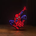 Front view of Spider-Man LED lightbox sign glowing on a wooden desk