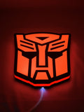 Autobot LED Light Box (20cm) - Illuminated flat lay angled view, perfect for garage and man cave decor