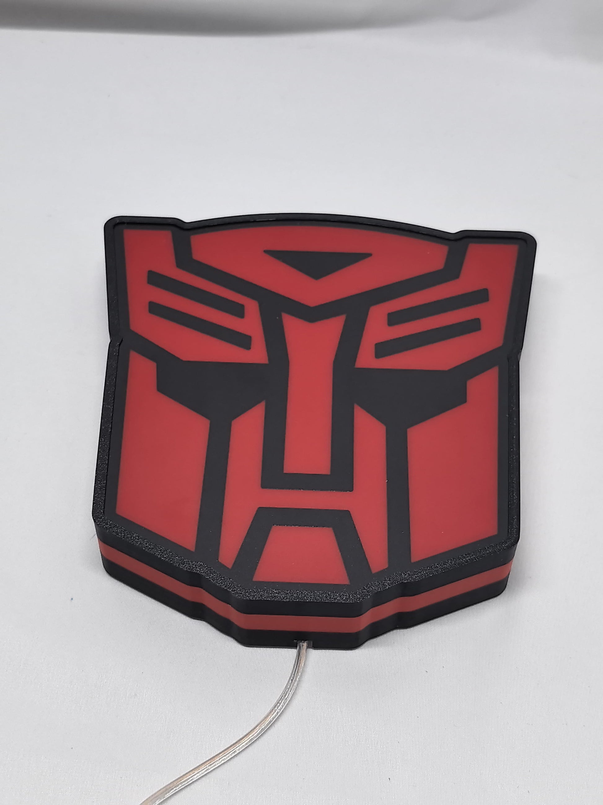 Unlit flat lay angled details of Autobot Illuminated Sign in 20cm, perfect for garage and man cave decor
